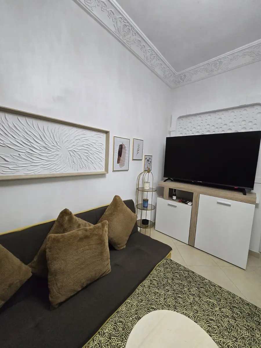 Living room sofa, television, and wall-mounted mini-split