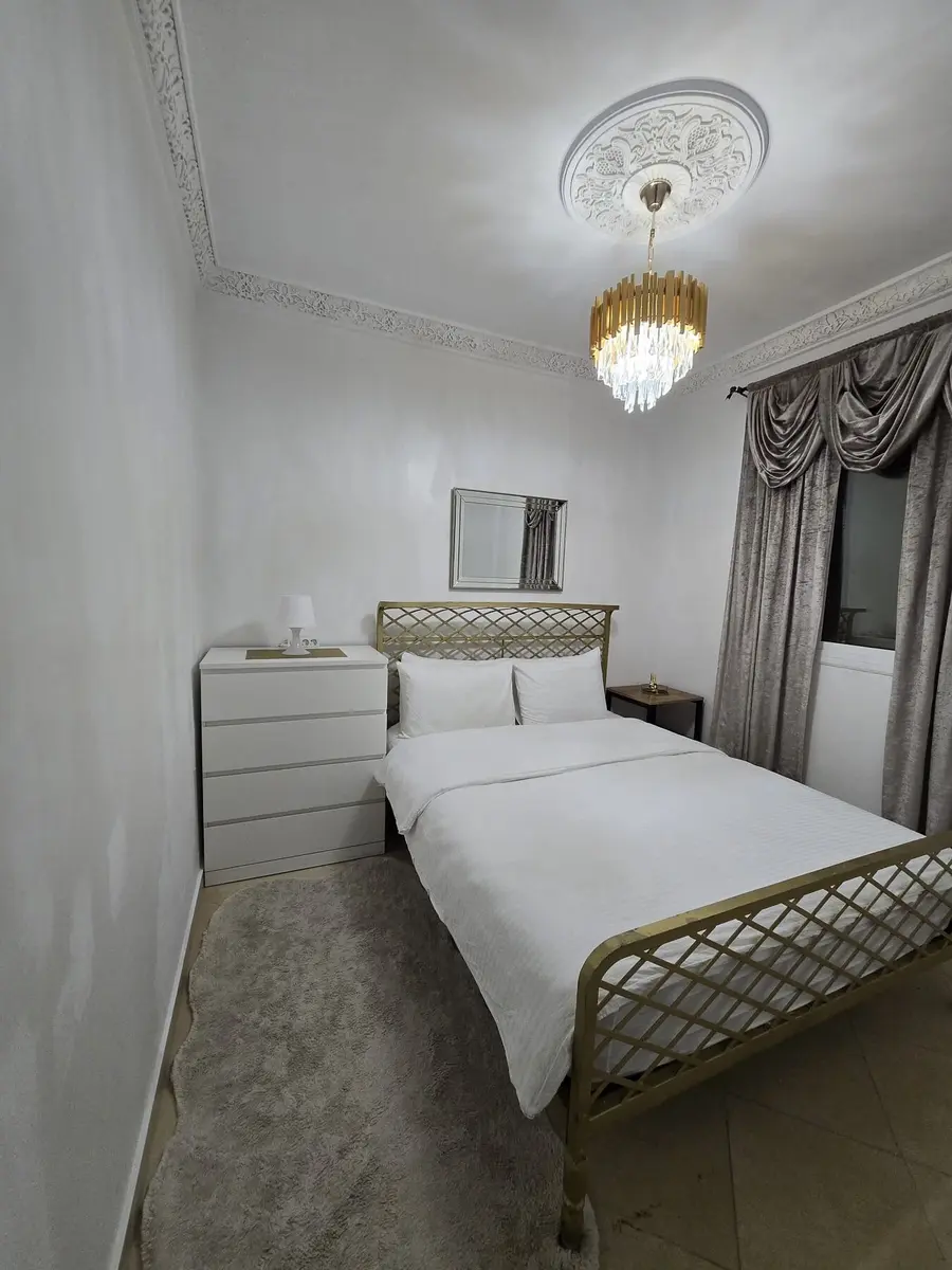 Queen bedroom with storage and traditional ceiling detail