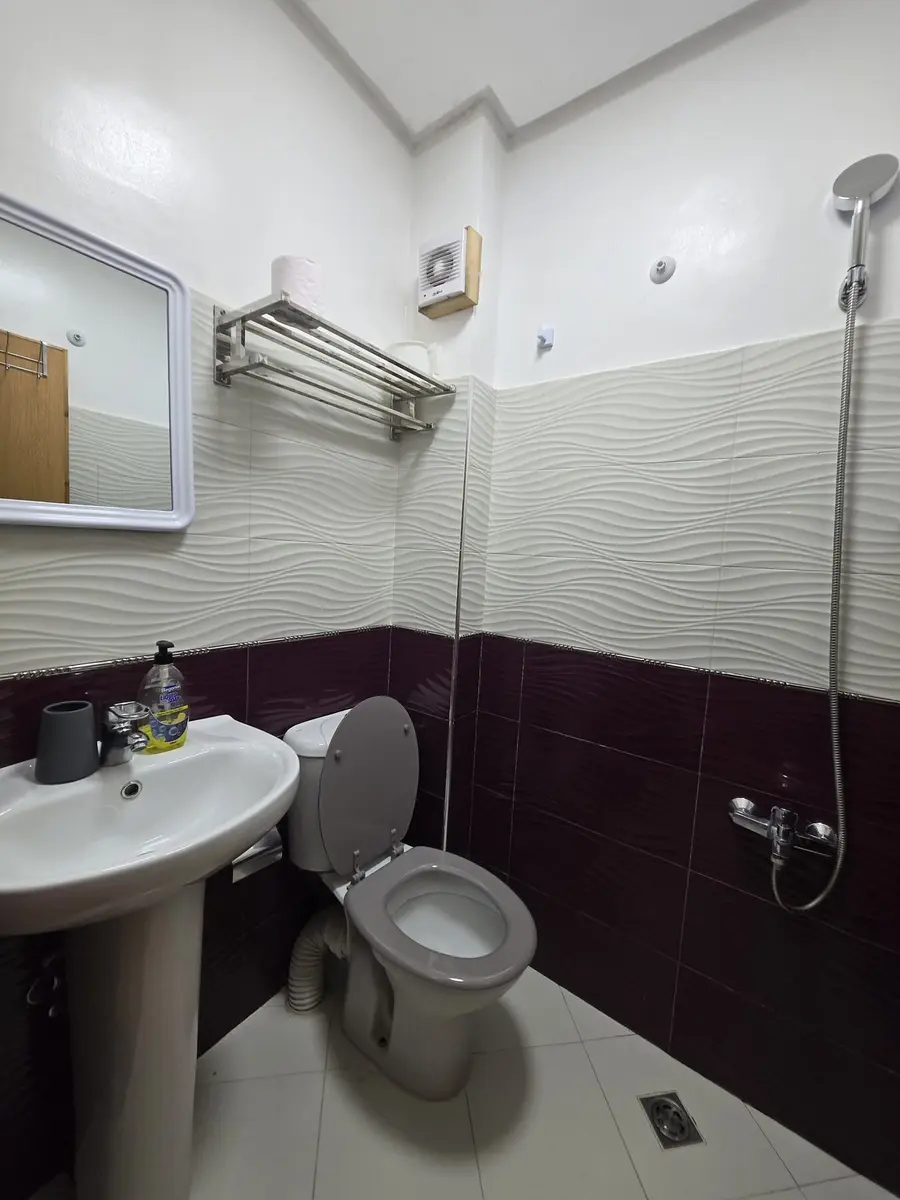Private bathroom with shower, sink, and toilet