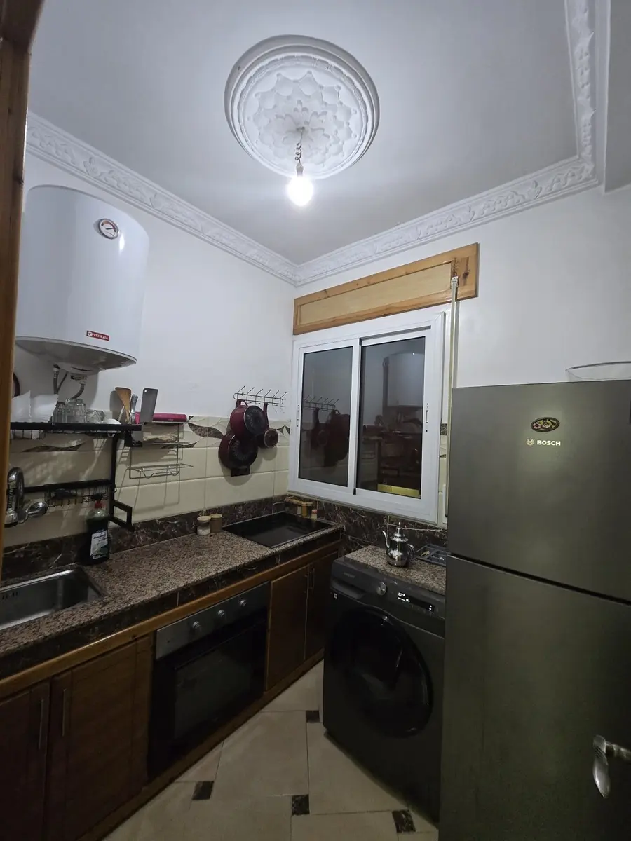 Apartment kitchen with refrigerator and window