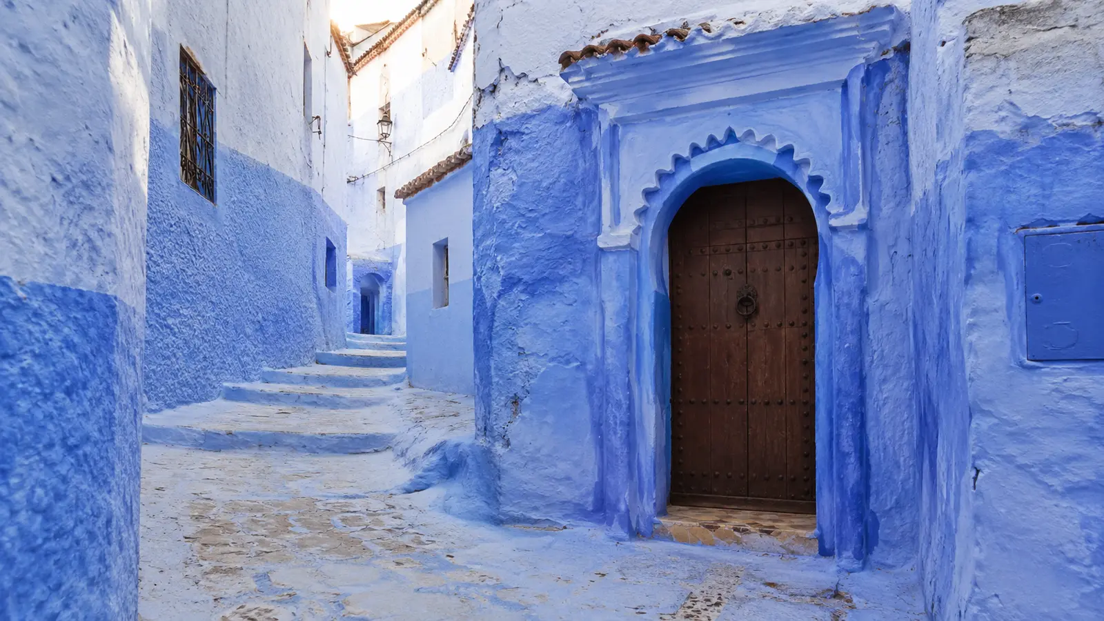 Quiet blue-painted lane and doorway in Chefchaouen medina