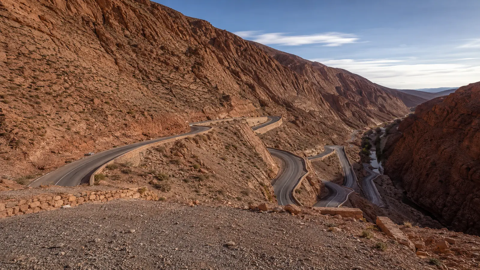Dades Valley road switchbacks between layered red-rock slopes